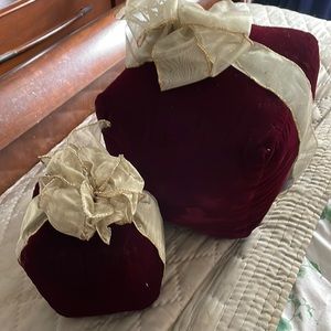 Two red velvet with golden ribbons for Christmas to put on your couch or around